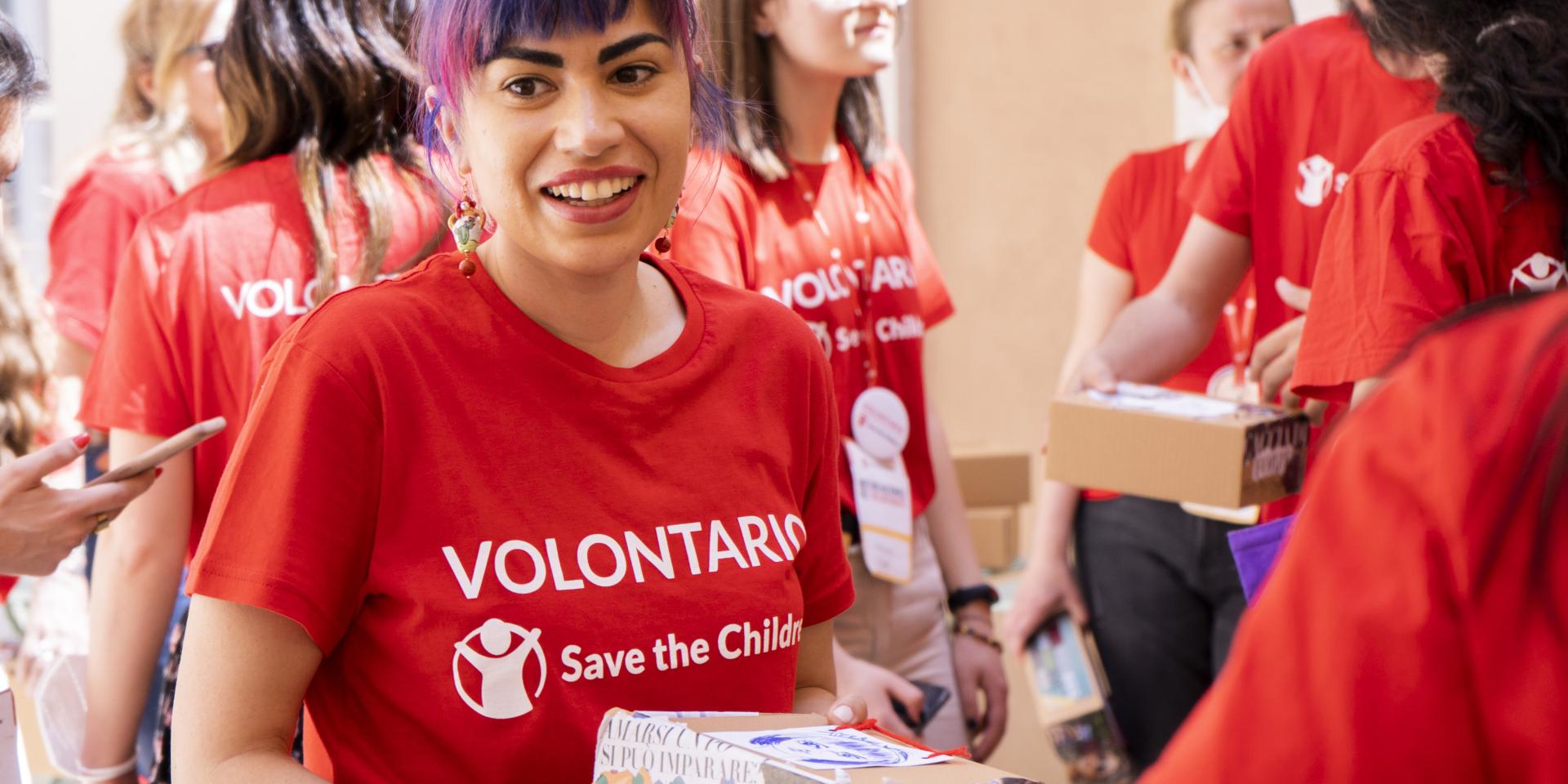 Una volontaria sorride durante un’attività laboratoriale realizzata nell’ambito del Meeting Nazionale del Volontariato di maggio 2022 di Save the Children
